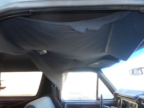 1986 Ford Bronco - The headliner in this vehicle is detached and sagging, obscuring the interior lights.