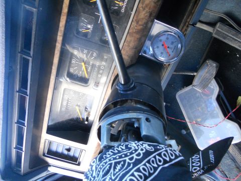 1986 Ford Bronco - Interior view of a vehicle's dashboard and steering column, showing various gauges and controls.