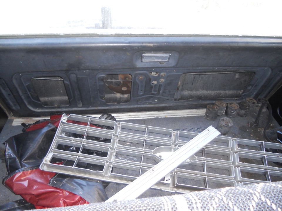 Silver grille and engine parts in cargo area