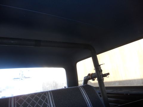 1986 Ford Bronco - Interior view of a 1986 Ford Bronco, highlighting the roll cage and seat upholstery.