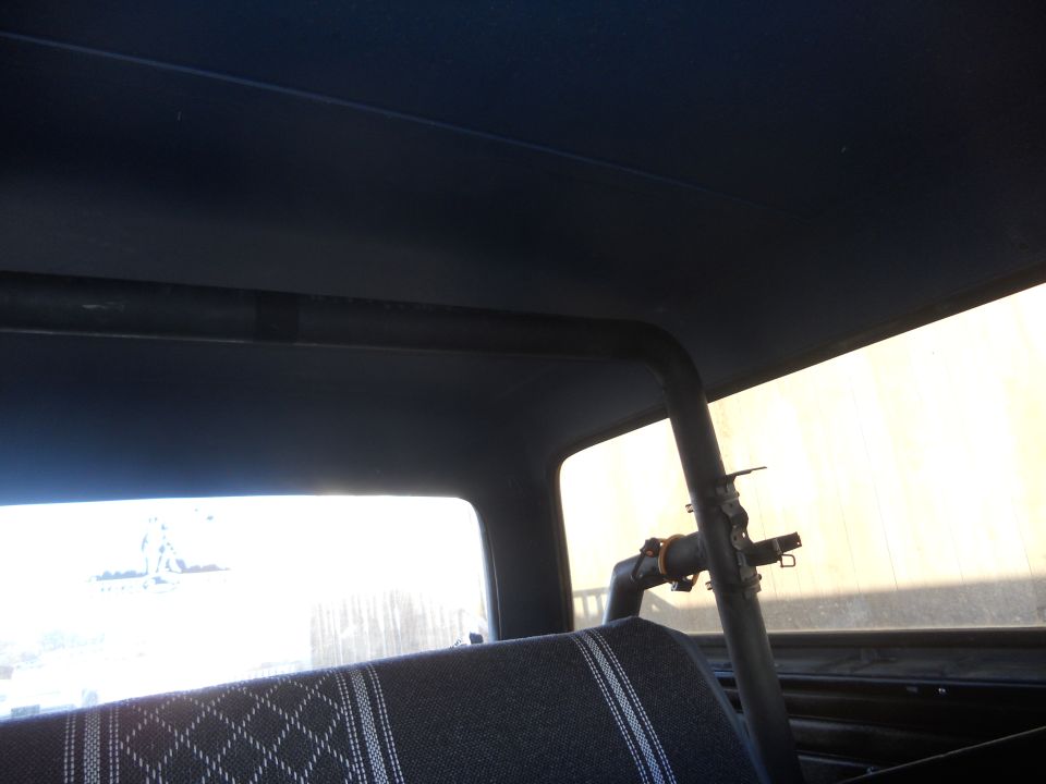 1986 Ford Bronco interior showing roll cage and patterned seat