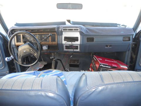1986 Ford Bronco - Interior view of a 1986 Ford Bronco, showing the dashboard, steering wheel, and seats.