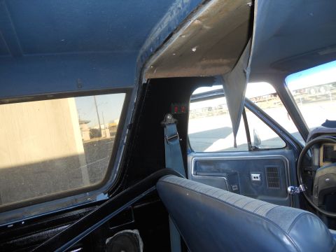 1986 Ford Bronco - Interior view of a 1986 Ford Bronco, highlighting the blue upholstery and door trim.