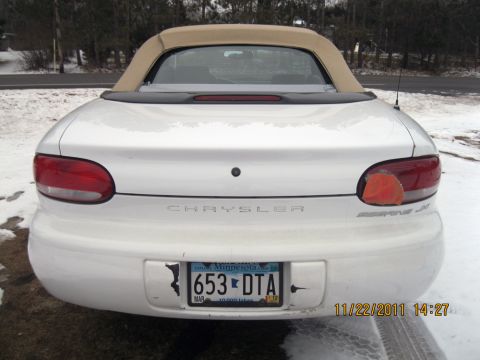 1984 Chevrolet C/K Pickup - Rear view of a white convertible with a tan top, showing the Chrysler badging and a Minnesota license plate.