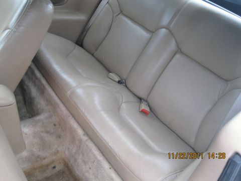 1984 Chevrolet C/K Pickup - Rear interior view of tan leather seats and carpeted floor.