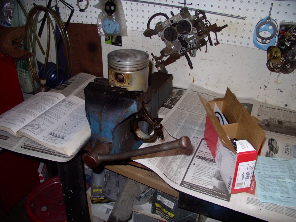 Cleaned piston ready for new rings, in box to right. Mahle instructions further right and the ever present factory service manual on the left.