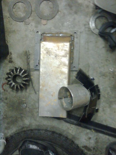 1984 Ford Bronco - Metal fabrication project in progress, showing various parts and a tire on the floor.