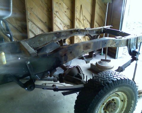 1978 Chevrolet C/K Pickup - This truck frame, likely from the mid-1970s, is undergoing restoration or repair.