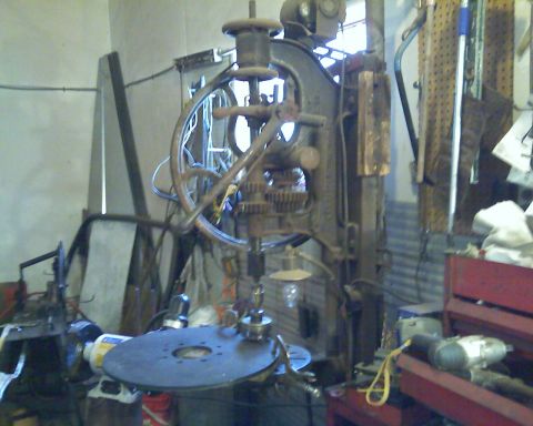 1978 Chevrolet C/K Pickup - A vintage drill press is the main subject in this cluttered workshop scene.