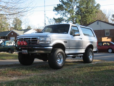 1994 Ford Bronco - This 1994 Ford Bronco features a custom front bumper with auxiliary lights and a two-tone silver paint scheme.