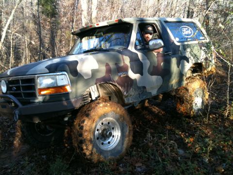 1995 Ford Bronco - This 1995 Ford Bronco is navigating a muddy, wooded path.