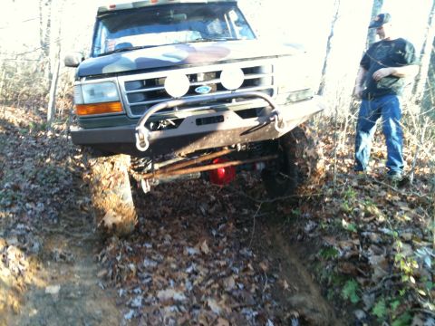 1995 Ford Bronco - This 1995 Ford Bronco is navigating a muddy, wooded trail.