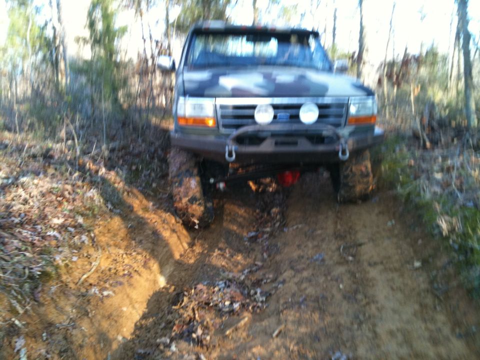 1995 Ford Bronco front view off-roading on a muddy trail