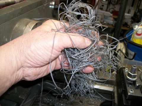1996 Ford Bronco - Metal shavings are collected in a hand after being cut on a lathe.