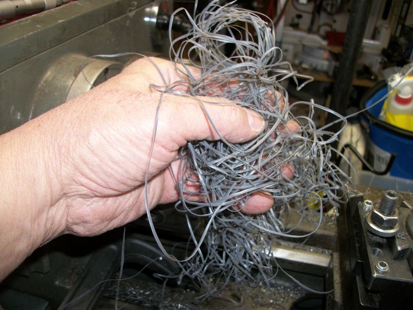 Hand holding a pile of metal shavings from a lathe
