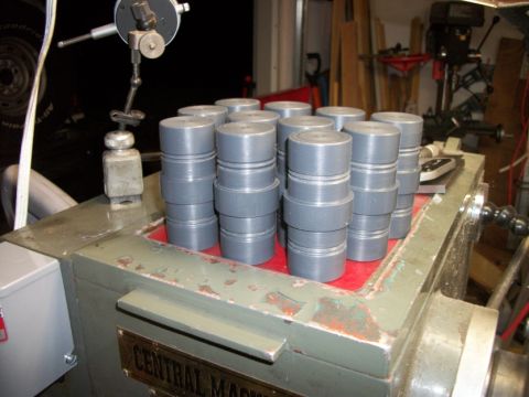 1996 Ford Bronco - A collection of machined parts sits on a workbench next to a dial indicator and other shop equipment.