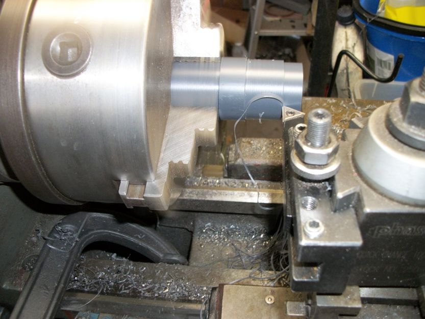 Metal rod on lathe chuck with cutting tool