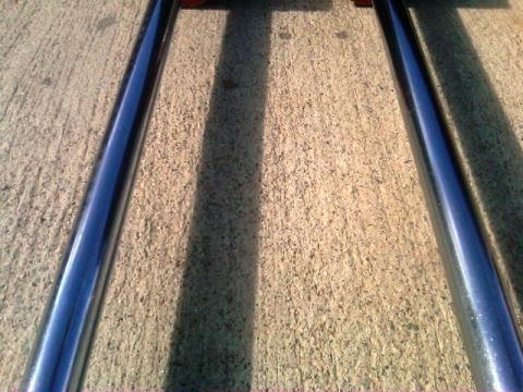 1986 Ford Bronco - Chrome side steps are shown resting on a concrete surface.