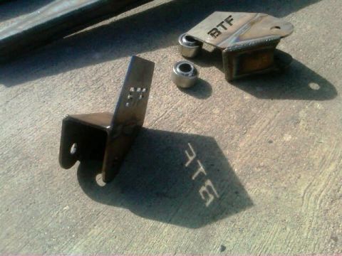 1986 Ford Bronco - BTF suspension parts and bearings shown on a concrete surface.