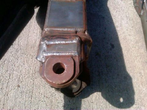 1986 Ford Bronco - This photo shows a custom metal bracket, likely for automotive modification, on a concrete surface.
