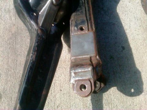 1986 Ford Bronco - Welded suspension parts are shown resting on a concrete surface, with a watermark for SuperMotors.net visible.