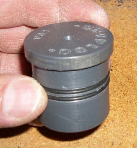 1996 Ford Bronco - A gray plastic part with two O-rings and embossed text 'LOCK USA' is held by a hand.