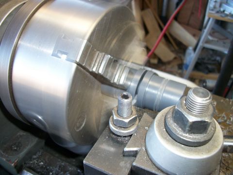 1996 Ford Bronco - A close-up view of a metal part being machined on a lathe, held securely by the chuck.