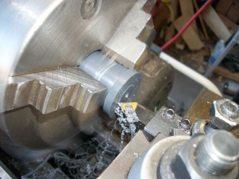 1996 Ford Bronco - Metalworking on a lathe, shaping a cylindrical part with a cutting tool.