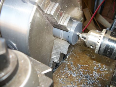1996 Ford Bronco - A part is being machined on a metal lathe with metal shavings accumulating on the surface.