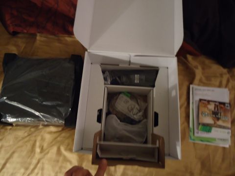 1992 Nissan 240SX - Unboxed electronics and game cases are laid out on a bed, with a SuperMotors watermark at the bottom right.