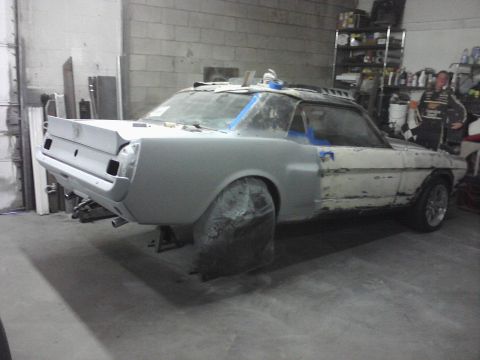 1966 Ford Mustang - This 1966 Ford Mustang coupe is in the process of body repair, showing primer and some exposed original paint.