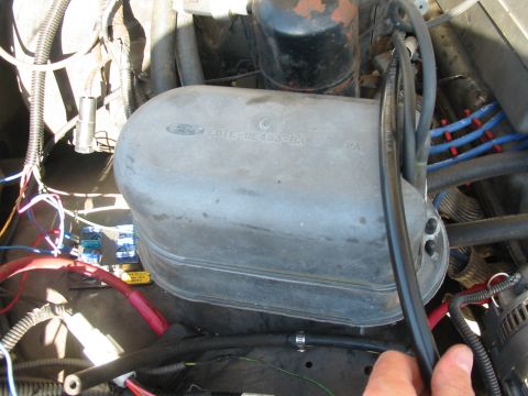 1992 Ford Bronco - Close-up of a Ford vacuum reservoir, part number E0TE-9E493-BA is legible.