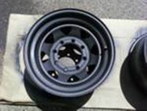 1989 Ford Bronco - A single vehicle wheel is shown in detail, resting on a light-colored surface.