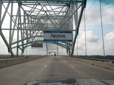 1989 Ford Bronco - Driving across a bridge, the "Welcome to Arkansas" sign is visible above the roadway.