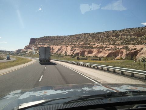 1989 Ford Bronco - Driving on a highway with a semi-truck in front and a mountainous landscape.