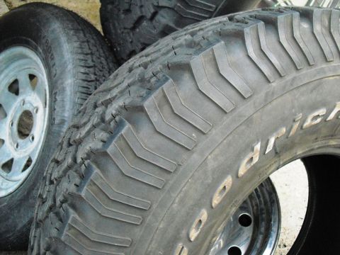 1986 Ford Bronco - Close-up of BFGoodrich All-Terrain tires, showing tread detail and sidewall lettering.