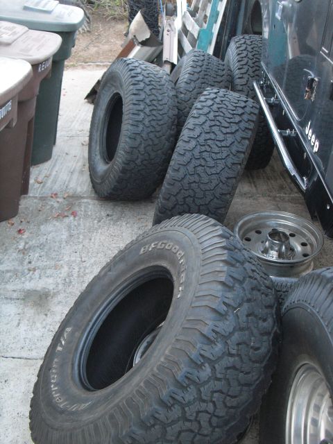 1986 Ford Bronco - Tires and a Jeep are visible in this outdoor scene.