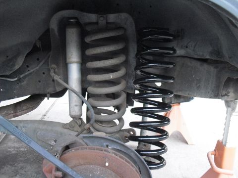 1986 Ford Bronco - Old and new coil springs are shown side-by-side, along with a shock absorber.