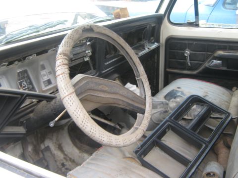1978 Ford Bronco - Interior view of a 1978 Ford Bronco, showing its aged dashboard and steering wheel.
