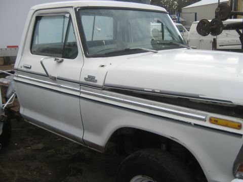 1978 Ford Bronco - This white Ford F-Series truck, identified by its 'F250 Custom' badging, is shown from a 3/4 front angle.