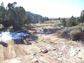1979 Ford Bronco - Off-road landscape with a distant white vehicle under a clear sky.