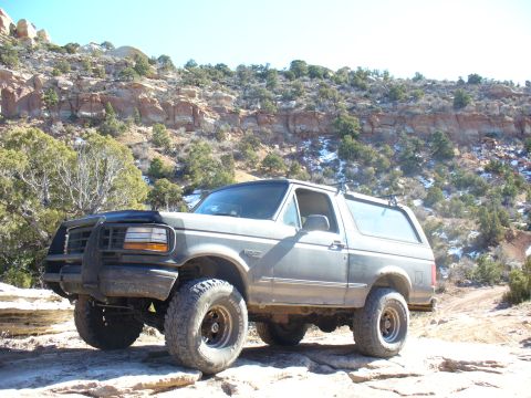1979 Ford Bronco - This Ford Bronco is parked on a rocky trail with a mountainous landscape behind it.