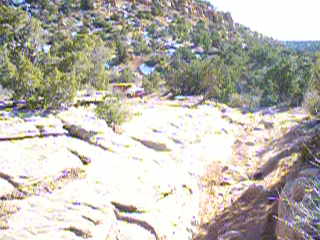 1979 Ford Bronco - A yellow vehicle navigates a , rocky landscape, with a SuperMotors logo visible at the bottom right.