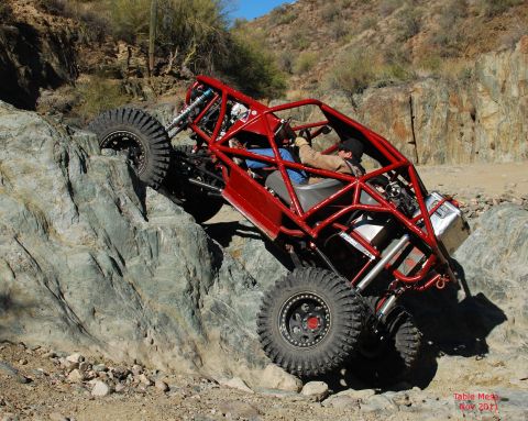 Suzuki Samurai - This custom-built buggy navigates a challenging rocky incline, its off-road capabilities.
