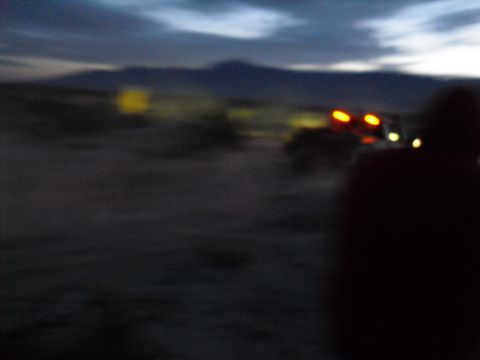 1986 Ford Bronco - Off-road vehicles are visible in a desert scene as daylight fades.