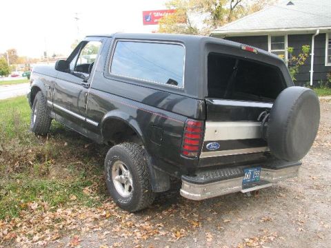 1993 Ford Bronco - Rear view of a 1993 Ford Bronco with a spare tire on the tailgate.