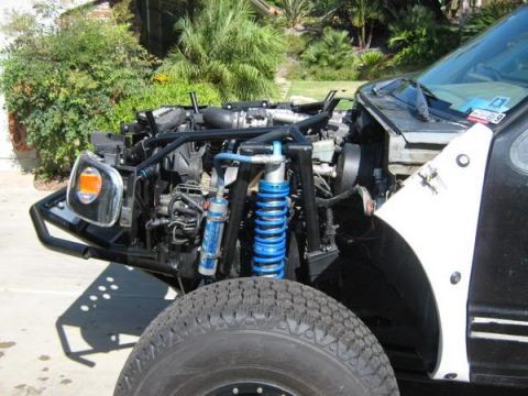 1993 Ford Explorer - Custom off-road vehicle with exposed engine and suspension components, modified for off-road use.