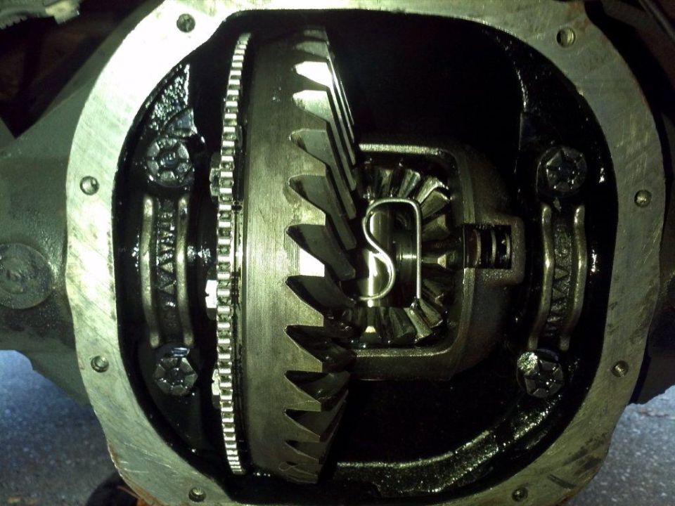 close-up of open differential gears with a c-clip visible