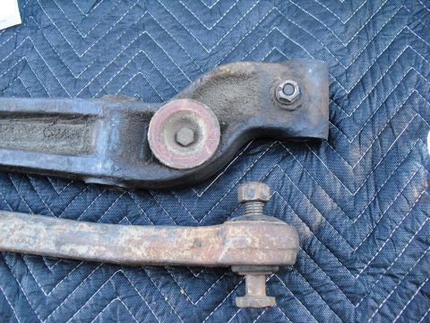 1986 Ford Bronco - Close-up view of automotive steering linkage components laid out on a blue quilted mat.