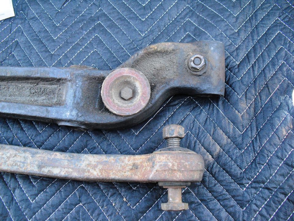 Steering linkage parts on a blue quilted surface